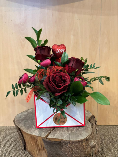 Love Letter - Send a message straight from your heart with this delightful envelope arrangement of romantic flowers